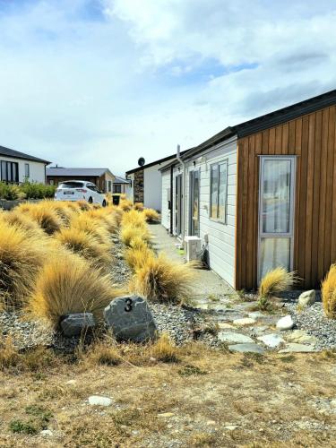 a row of houses in a field of tall grass at 3 Edwards in Lake Tekapo