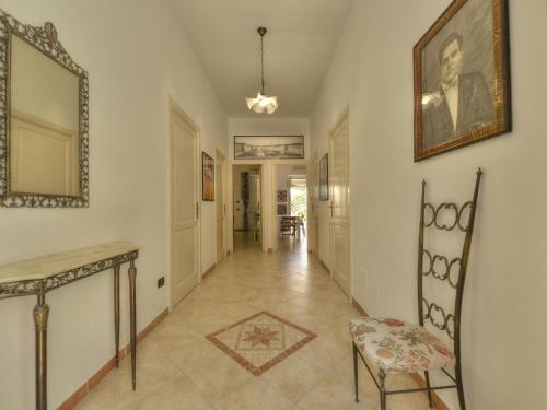 a hallway with a table and a chair and a mirror at Vacation home with private pool, Floridia in Floridia