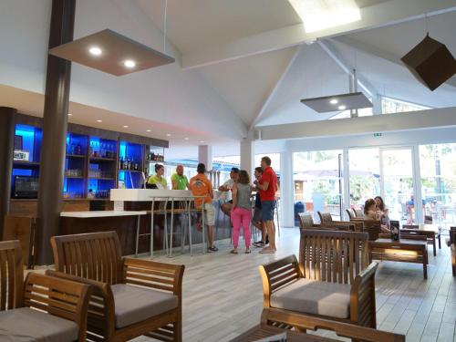 un groupe de personnes debout dans un restaurant dans l'établissement Holiday Home in France near Atlantic Beach, à Moliets-et-Maa