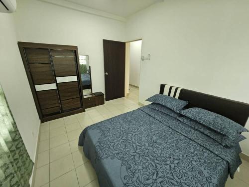 a bedroom with a blue bed and a dresser at A&H Homestay Seberang Jaya with Swimming Pool & 3 Bedroom AC in Permatang Janggus