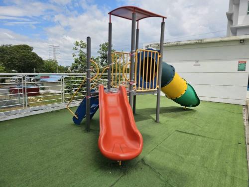 a playground with a slide at A&H Homestay Seberang Jaya with Swimming Pool & 3 Bedroom AC in Permatang Janggus