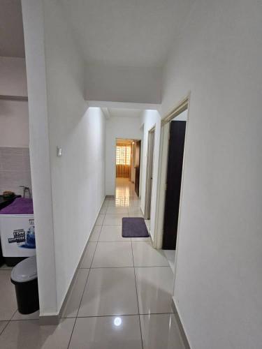 a hallway with white walls and a tile floor at A&H Homestay Seberang Jaya with Swimming Pool & 3 Bedroom AC in Permatang Janggus