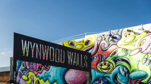 a sign in front of a wall covered in graffiti at mary jane room in Miami