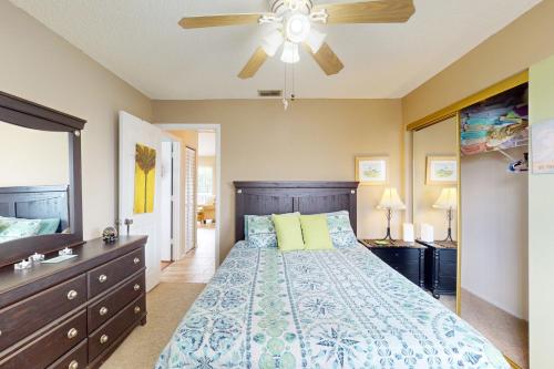 a bedroom with a bed and a ceiling fan at Salt, Sand, Sea in North Port