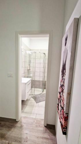 a bathroom with a shower and a sink and a mirror at Ljubljana Central Cozy Apartment w Free Parking in Ljubljana