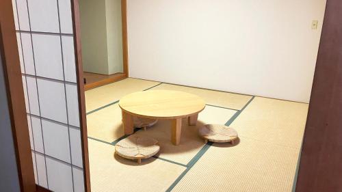 a small table and two stools in a room at Grand Mercure Nasu Highlands Resort & Spa in Nasu