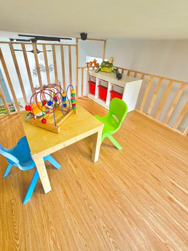 a room with a table and chairs and a staircase at KidsVille Slide LoftPlay Safari, Afiniti I 5mins Walk to Legoland JB, Johor Bahru, Malaysia in Nusajaya