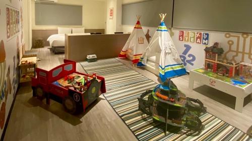 ein Zimmer mit Spielzeugautos und ein Schlafzimmer mit einem Bett in der Unterkunft Hotel Lounge in Toucheng
