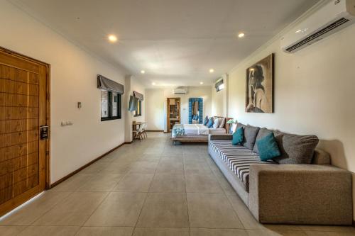 a living room with a couch and a table at Komodo Suites Downtown in Labuan Bajo