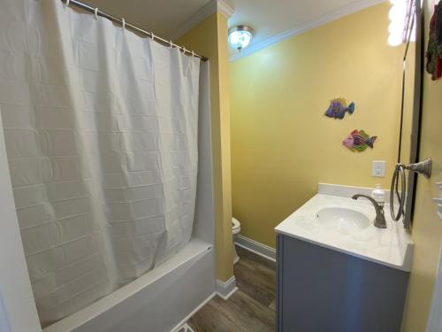 a bathroom with a sink and a shower at 2 if by Sea- East Unit in Emerald Isle