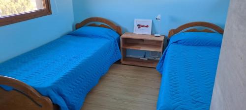 2 Betten nebeneinander in einem Zimmer in der Unterkunft Alfa & Omega in Dina Huapi