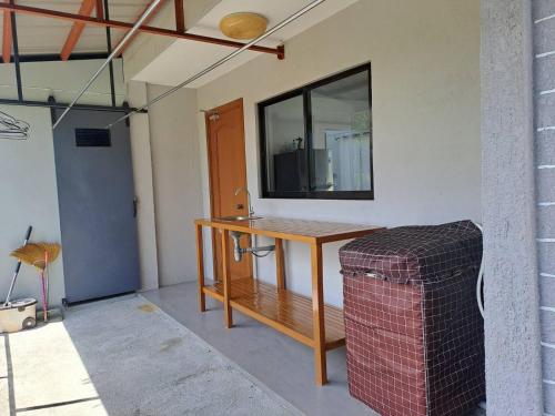 a room with a wooden table and a trash can at Mango Prima in Moalboal