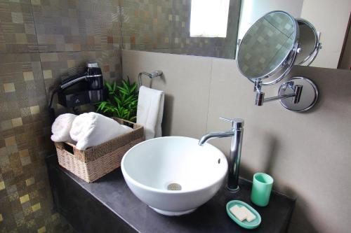 a bathroom with a sink and a mirror on a counter at Banana's Adventure Hostel in Ica