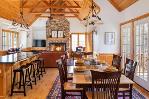 a dining room with a table and chairs and a fireplace at The Lodge, 'North Woods' style, boutique Galena Getaway! in Galena