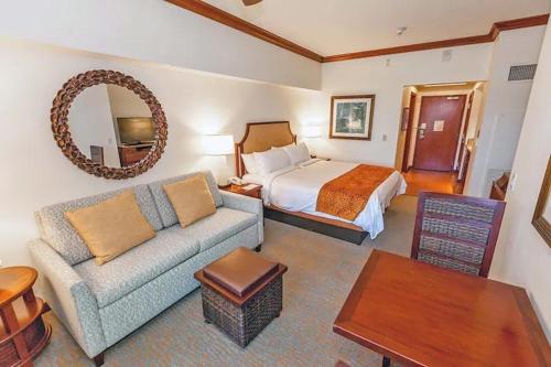 a hotel room with a bed and a couch at Marriott Ko olina beach club in Honokai Hale