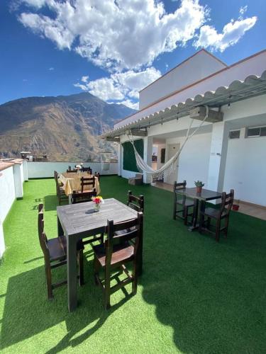 a patio with a table and chairs on a lawn at Hotel Sol de Canta in Canta