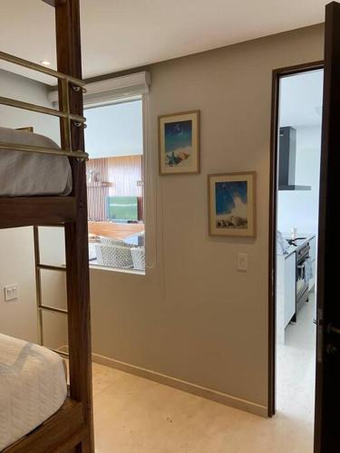 a bedroom with a bunk bed and a window at Increíble departamento en Bolongo punta de mita in Higuera Blanca