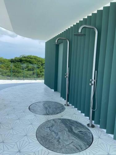 a bathroom with two shower stalls in a building at Increíble departamento en Bolongo punta de mita in Higuera Blanca