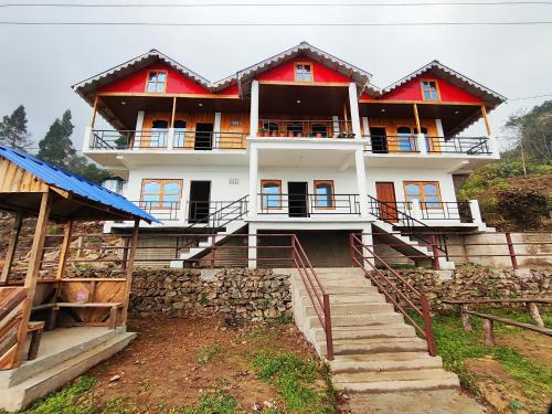 a large house with stairs in front of it at Mount View Homestay Sittong in Mangpu