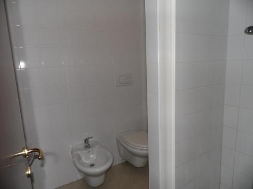 a bathroom with a toilet and a sink at Ai Vecchi Tempi in Frattocchie
