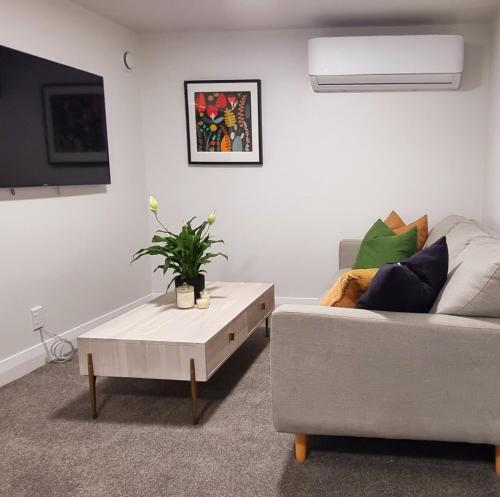 a living room with a couch and a coffee table at City Fringe Apartment with garage in Wellington
