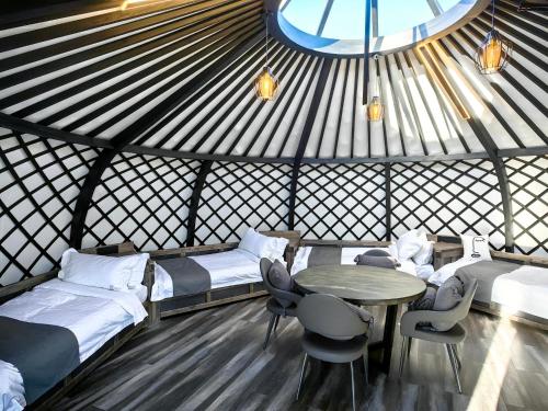 a room with beds and a table in a yurt at Tsomtsog Ger, Seven Nuga Resort 