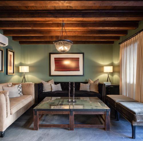 a living room with a couch and a table at Private Jacuzzi & Pool, Elegant La Escondida 5BR in San Miguel de Allende