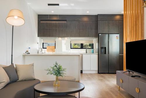 a living room with a couch and a table at Your home away from home located near Auckland CBD in Auckland