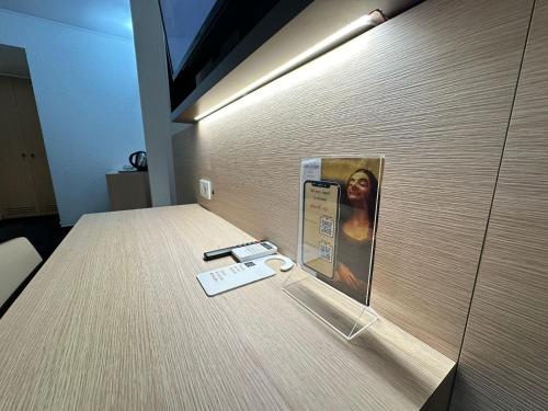 a door with a cell phone and a card on it at Hotel Le Paris in Noumea
