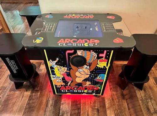 a nintendo wii arcade game on top of a table at Cozy Cabin, Sleeps 8 - Close to Dollywood with Hot Tub, Arcade, Community Pool in Pigeon Forge