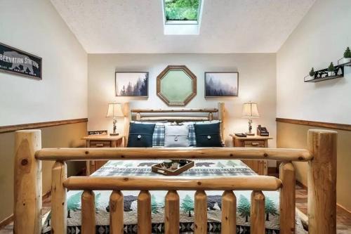 a bedroom with a bed with a wooden frame at Cozy Cabin, Sleeps 8 - Close to Dollywood with Hot Tub, Arcade, Community Pool in Pigeon Forge