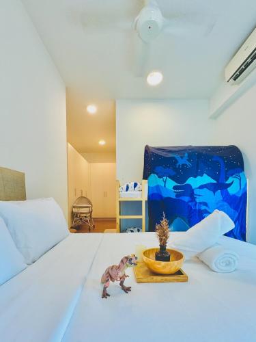 a bedroom with a bed with a toy dinosaur on it at KidsVille Slide LoftPlay Safari, Afiniti I 5mins Walk to Legoland JB, Johor Bahru, Malaysia in Nusajaya