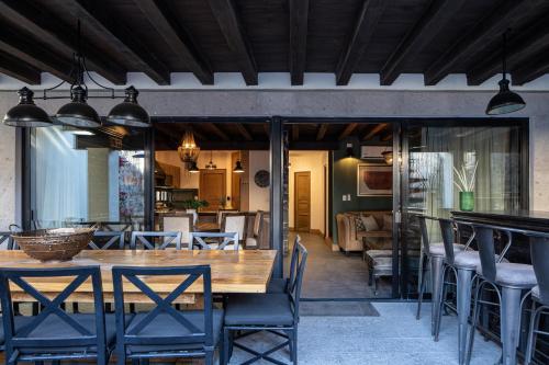 a dining room with a wooden table and chairs at Private Jacuzzi & Pool, Elegant La Escondida 5BR in San Miguel de Allende