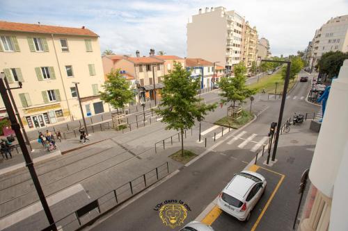 a white car parked on a city street with buildings at l'Or dans la Mer 3 in Nice