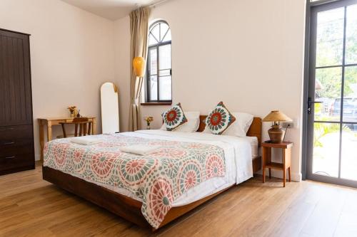 a bedroom with a large white bed with a bedspread at SeaSalt BeachFront Holiday Home, Private pool, 2 Bedroom house in Chaloklum