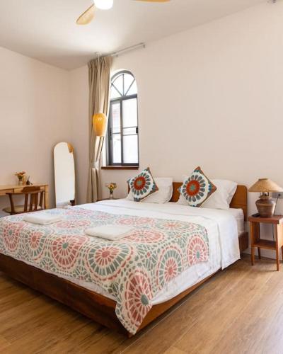 a bedroom with a large bed and a window at SeaSalt BeachFront Holiday Home, Private pool, 2 Bedroom house in Chaloklum