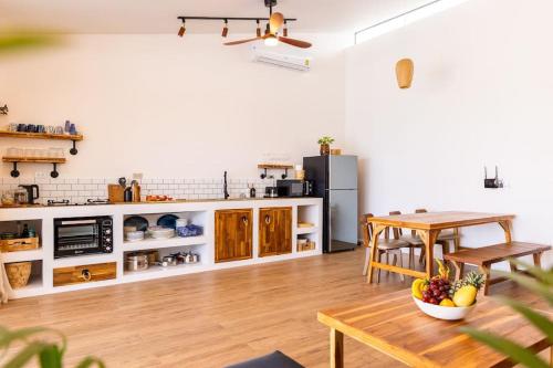 a kitchen with a table and a dining room at SeaSalt BeachFront Holiday Home, Private pool, 2 Bedroom house in Chaloklum