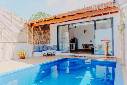 a house with a swimming pool and a patio at SeaSalt BeachFront Holiday Home, Private pool, 2 Bedroom house in Chaloklum