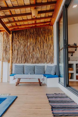 a living room with a couch and a pool at SeaSalt BeachFront Holiday Home, Private pool, 2 Bedroom house in Chaloklum