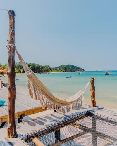 a hammock on a pier with the ocean at SeaSalt BeachFront Holiday Home, Private pool, 2 Bedroom house in Chaloklum