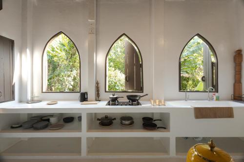 a kitchen with a stove and three windows at Huge 8 Bedrooms Pool Villa, Chiang Mai gem, Tanpuri Patan, perfect for Groups in Chiang Mai