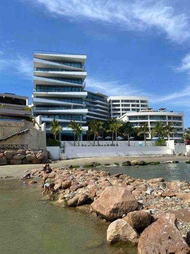 a group of buildings and rocks in the water at Increible vista en Bucerias en Narval Norte!!! in Bucerías
