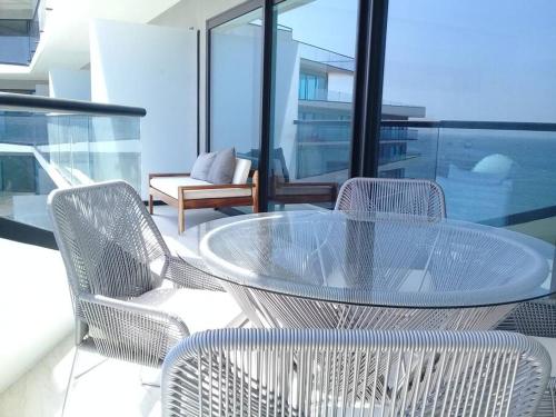 a glass table and chairs on a balcony at Increible vista en Bucerias en Narval Norte!!! in Bucerías