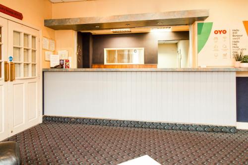 a bar in a restaurant with a counter top at OYO The Contractor Hotel in South Bank