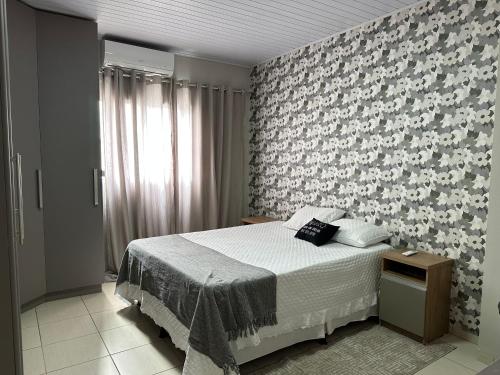 Ένα ή περισσότερα κρεβάτια σε δωμάτιο στο VILINHA LOFT HOME AP- 02 - TÉRREO - Excelente Localização