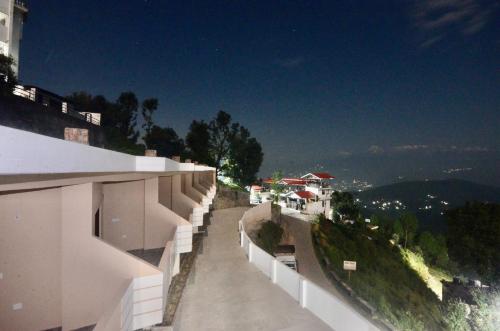 a view from the side of a building at Uttarakhand resort in Kausani
