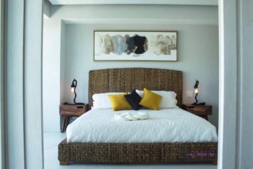 a bedroom with a large bed with yellow and black pillows at Best View in Marina puerto Vallarta in Puerto Vallarta