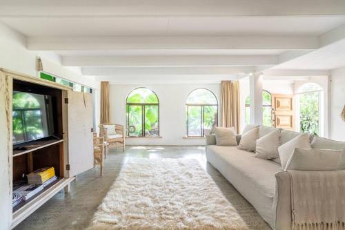 a living room with a couch and a tv at Studio Birdsong in East Ballina