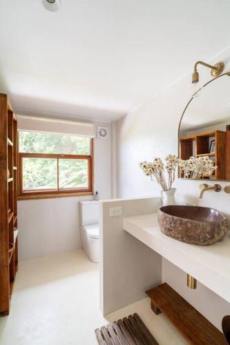a bathroom with a sink and a toilet at Studio Birdsong in East Ballina