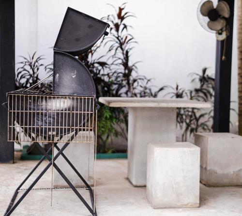 a black chair sitting next to a table at Sandy Bliss Villa in Sri Jayewardenepura Kotte